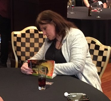 Marie O'Regan signing a copy of The Alchemy Press Book of Horrors, edited by Peter Coleborn and Jan Edwards