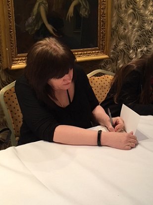 Marie O'Regan signing copies of her novella, Bury Them Deep