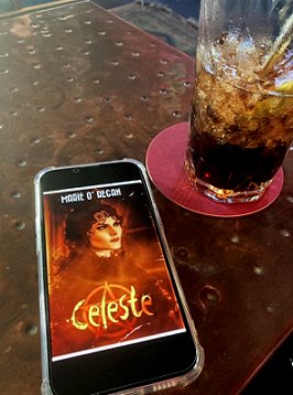 Celeste by Marie O'Regan on mobile phone, drink