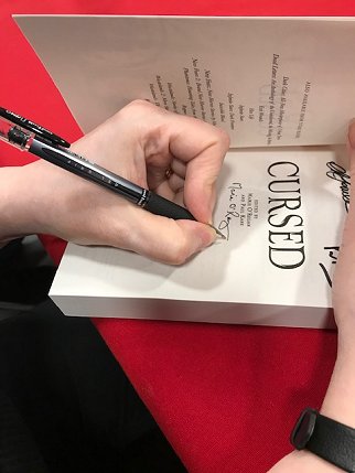 Marie O'Regan signing a copy of Cursed