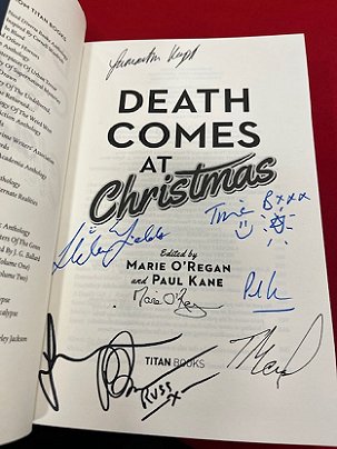 title page of a signed Death Comes at Christmas, edited by Marie O'Regan and Paul Kane. Features signatures of: Samantha Hayes, Helen Fields, Tina Baker, Marie O'Regan, Paul Kane, Fiona Cummins, Tom Mead, Russ Thomas