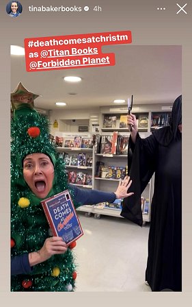 screenshot from tinabakerbooks on TikTok. Still from video of Tina, dressed as a Christmas tree and holding a copy of Death Comes at Christmas, edited by Marie O'Regan and Paul Kane, being chased by Russ Thomas (dressed as Death and wielding a plastic cleaver)