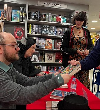 Tom Mead signing a copy of his book at Forbidden Planet. Behind him is Russ Thomas