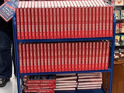 photograph of a trolley with three shelves, packed with signed copies of Death Comes at Christmas, edited by Marie O'Regan and Paul Kane