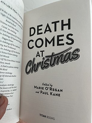 photograph of an open copy of Death Comes at Christmas, edited by Marie O'Regan and Paul Kane, open to show the title page