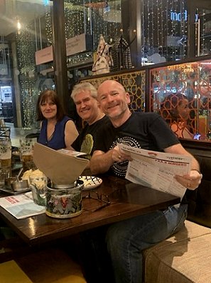 L to R: Marie O'Regan, Paul Kane and Tim Lebbon, seated in a restaurant at night