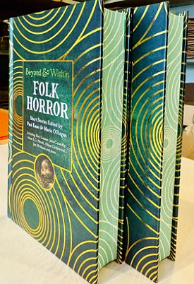 photograph of two copies of Beyond and Within Folk Horror, edited by Paul Kane and Marie O'Regan, standing on a cream surface