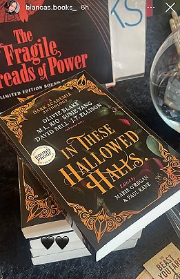 Image of a stack of five copies of In These Hallowed Halls, edited by Marie O'Regan and Paul Kane, on a black surface