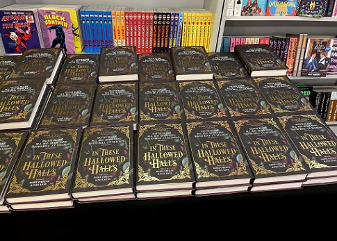 Display of a table full of copies of In These Hallowed Halls, edited by Marie O'Regan and Paul Kane