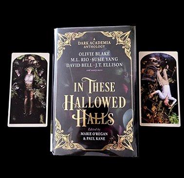Copy of In These Hallowed Halls, edited by Marie O'Regan and Paul Kane, lying on a black background, between two cards - the lefthand one featuring a prone female character, the righthand a prone male character