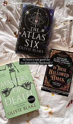 Image of three books lying on a cream cloth decorated with yellow flowers. The Atlas Six and Masters of Death by Olivie Blake, and In These Hallowed Halls, edited by Marie O'Regan and Paul Kane