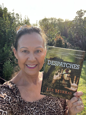 author Lee Murray holding up a copy of her Absinthe Books novella DESPATCHES, which is on the preliminary ballot for the Bram Stoker Awards®