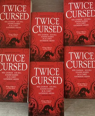 Display featuring six copies of Twice Cursed, edited by Marie O'Regan and Paul Kane