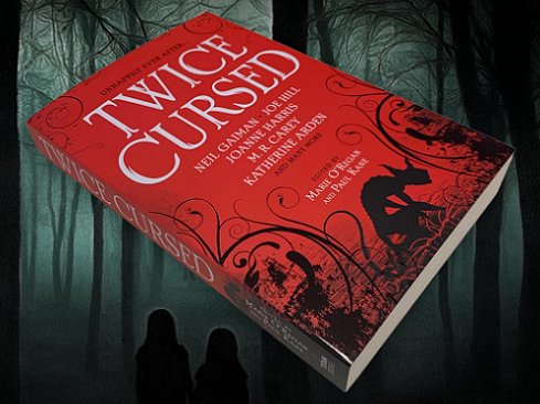 Image showing a copy of Twice Cursed, edited by Marie O'Regan and Paul Kane, lying over an image of a dark forest, with two small children silhouetted in the foreground