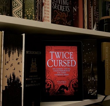 Bookshelf display featuring Twice Cursed, edited by Marie O'Regan and Paul Kane