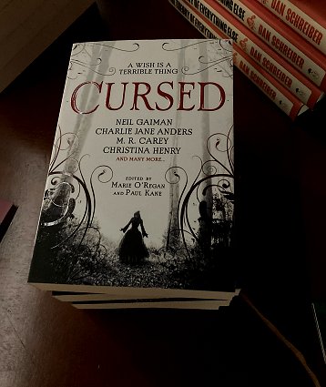 Display of copies for sale of Cursed, edited by Marie O'Regan and Paul Kane