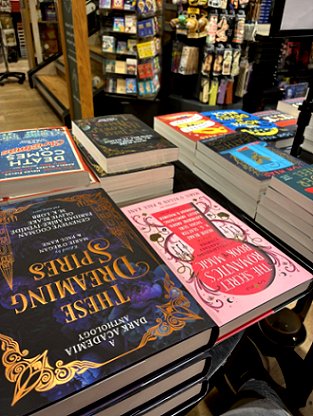 photograph of a book display, featuring These Dreaming Spires, The Secret Romantic's Book of Magic, In These Hallowed Halls and Death Comes at Christmas, all edited by Marie O'Regan and Paul Kane