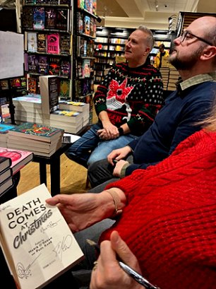 photograph of Russ Thomas and Tom Mead in Waterstones. Marie O'Regan can be seen signing a copy of Death Comes at Christmas, edited by Marie O'Regan and Paul Kane, at the front right of the picture