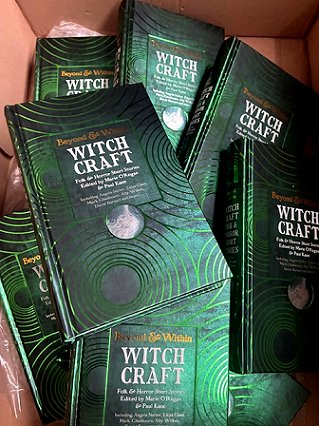 photograph of several copies of Beyond & Within: Witchcraft, edited by Marie O'Regan and Paul Kane, inside a cardboard box
